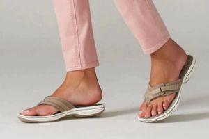 Stylish beige slide sandals perfect for beach or poolside comfort.