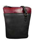 Black and red leather crossbody bag with contrast top panel, black straps and secure zip closure.