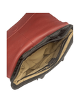 Interior of black leather backpack with light brown fabric lining, organizational pockets, red interior flap and detail stitching.