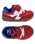 Pair of red toddler's hook-and-loop sneakers with white accents, blue lining, padded collar, white elastic lacing, blue Stride rite logo'd footbed and a brown gum outsole.