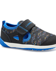 Black children's shoe with colorful shark outlines, blue lining and white and blue outsole.