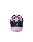 Heel of Navy children's shoe with colorful polka dots, pink lining and pink outsole..