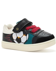 A toddler's low-top black sneaker with a soccer ball graphic that lights up, teal accent panels, red towel elastic laces, a hook-and-loop strap closure and white outsole.