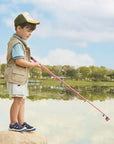 Toddler wearing navy Stride Rite Wade 2.0 Sandals while fishing outdoors, showcasing water-friendly comfort and rugged design for active play.
