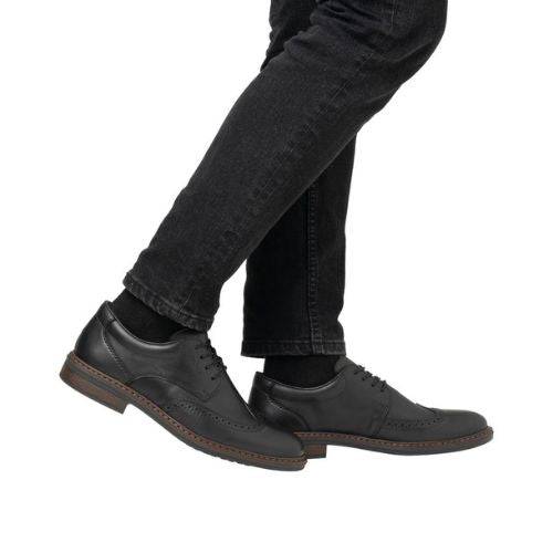 Black Rieker L7620 Baroque Dress Shoes styled with black jeans, highlighting their versatile and elegant design for men.