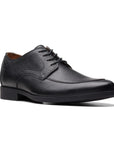 Lace up dress shoe with black crinkled leather upper and apron toe stitching.