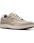Beige leather lace up sneaker with white midsole. Clarks logo is embossed at the heel.