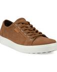 A light brown nubuck casual sneaker with a white midsole and brown outsole. A brown leather tag near the laces show the Ecco logo.