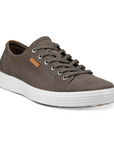 A light grey nubuck casual sneaker with a white midsole and brown outsole. A brown leather tag near the laces show the Ecco logo.
