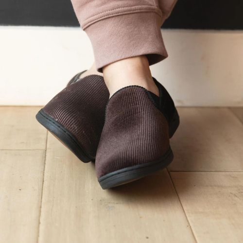 Man with crossed legs wearing the Regal 2 Slipper in Dark Brown.
