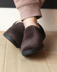Man with crossed legs wearing the Regal 2 Slipper in Dark Brown.