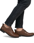 Brown step in dress shoes worn with black jeans.