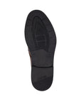 Black light treaded outsole of dress shoe with Rieker logo on heel.