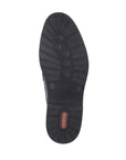 Black rubber outsole of men's penny loafer dress shoe with red Rieker logo on heel.
