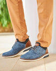 Casual sneakers in blue styled with tan pants.