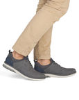 Gray sneakers worn with beige pants.
