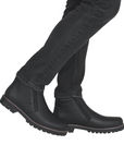 Man wearing black jeans and black dual zipper leather ankle boots.