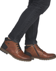 Brown dress boots with black jeans.