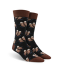 Cotton crew socks in black with brown trim, patterned with otters holding paws.