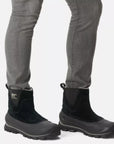 Men wearing Sorel Buxton Chelsea Boots with jeans, demonstrating the stylish, insulated, and waterproof fit for winter outings.