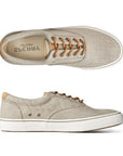 Beige canvas sneakers with white soles and brown laces, showcasing their comfort and durability from top and side views.