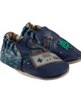 Pair of Blue baby shoes with soft soles featuring retro a game controller, spaceship, and pixelated alien designs.