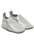 Silver glittery baby shoes with brown outsoles and stars on the heels.