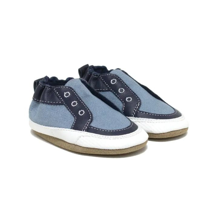 Blue denim and leather baby shoes with fake eyelets stitched on.