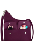 A deep purple one-shoulder crossbody bag with a shoulder strap and silver snap buttons, featuring two front utility pockets holding small accessories.