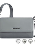 Small gray bag with removable straps and flap closure featuring the Travelon logo. Upper part of bag made of vegan leather, bottom part nylon
