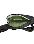Interior of black Travelon Anti-Theft Roam Compact Sling showing zippered compartments and light green lining.