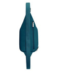 Side profile of teal blue Travelon Anti-Theft Roam Compact Sling with rear zipper and adjustable anti-theft strap.
