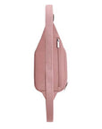 Side profile of blush pink Travelon Anti-Theft Roam Compact Sling featuring rear zippered pocket and adjustable strap.
