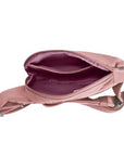 Interior view of blush pink Travelon Anti-Theft Roam Compact Sling showing organized compartments and secure zippered pocket.