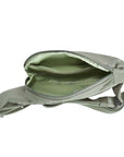 Interior of sage green Travelon Anti-Theft Roam Compact Sling showing spacious compartments and secure zippered section.