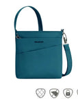Teal Travelon Anti-Theft Roam Small Crossbody Bag with front zip pocket and safety icons, ideal for secure travel use.