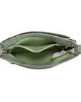 Interior of green Travelon Anti-Theft Roam Crossbody Bag showing light green lining and spacious compartments for essentials.
