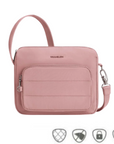 Travelon Anti-Theft Roam E/W Crossbody Bag in blush pink with front zip pocket and anti-theft icons, ideal for secure travel.