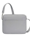 Back of light gray Travelon Anti-Theft Roam E/W Crossbody Bag with sleek design and adjustable strap for hands-free travel.