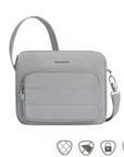 Light gray Travelon Anti-Theft Roam E/W Crossbody Bag with front zip pocket and anti-theft icons, ideal for secure urban travel.