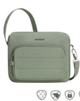 Sage green Travelon Anti-Theft Roam E/W Crossbody Bag with front zip pocket and anti-theft icons, perfect for secure daily use.