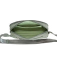 Interior of sage green Travelon Anti-Theft Roam Belt Bag showing spacious compartments and RFID protection for organized travel essentials.