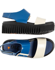 Pair of Blue and white backstrap sandals with blue Art logo'd footbed and a thick black ribbed outsole.