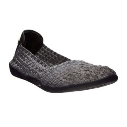 Bernie Mev Catwalk flat in pewter. The woven elastic upper is pewter metallic and the outsole is black. A small silver medallion with Bernie Mev branding is visible on the back of the heel. 
