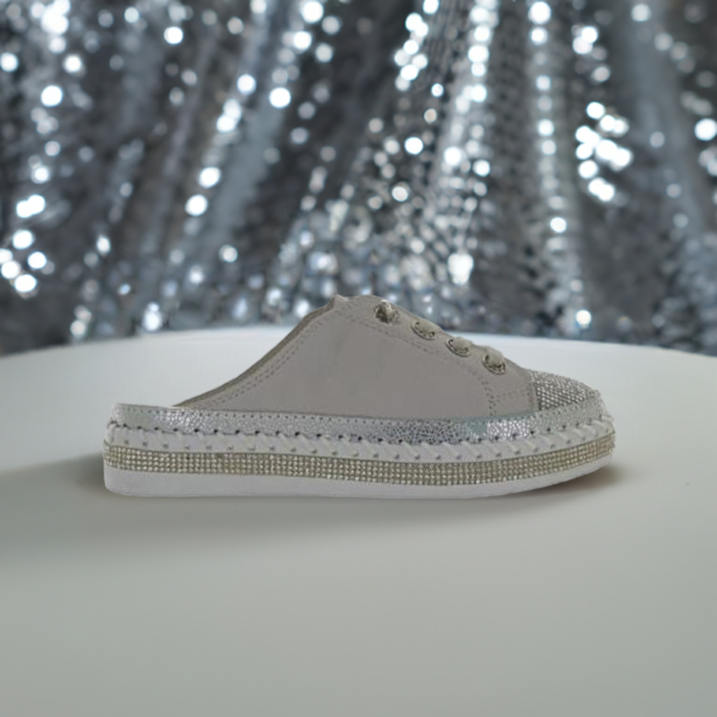 Bernie Mev TW Jive Clog for women displayed against a sparkly backdrop, emphasizing its glittery toe cap and stylish slip-on design.