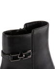Close-up of Blondo Avery boot's ankle buckle detail and smooth waterproof leather, showcasing premium craftsmanship.