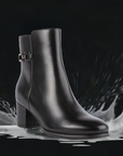 Blondo Avery women's waterproof heeled boot splashing in water, emphasizing sealed seams and weatherproof leather design.