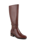 Knee height brown leather boot with low stacked heel and ruched leather along the calf.