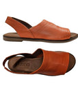 Top and side views of rust orange Bueno Hayden Sandal, highlighting soft leather craftsmanship and ergonomic design.
