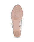 Tan light treaded outsole of Mary Jane shoe.